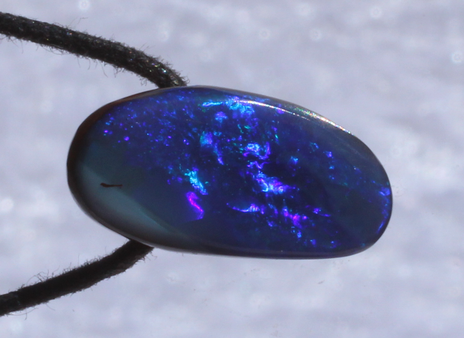 Blauer Boulderopal, seitlich gebohrt mit Lederband 